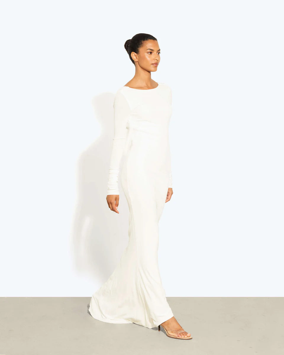 Woman wearing a cream long-sleeved fitted maxi dress with a crew neckline — Rat & Boa | Endless UAE