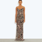 Woman wearing black and cream zebra stripe maxi dress with cowl neckline — Endless | Endless UAE