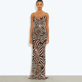 Woman wearing black and cream zebra stripe maxi dress with cowl neckline — Endless | Endless UAE