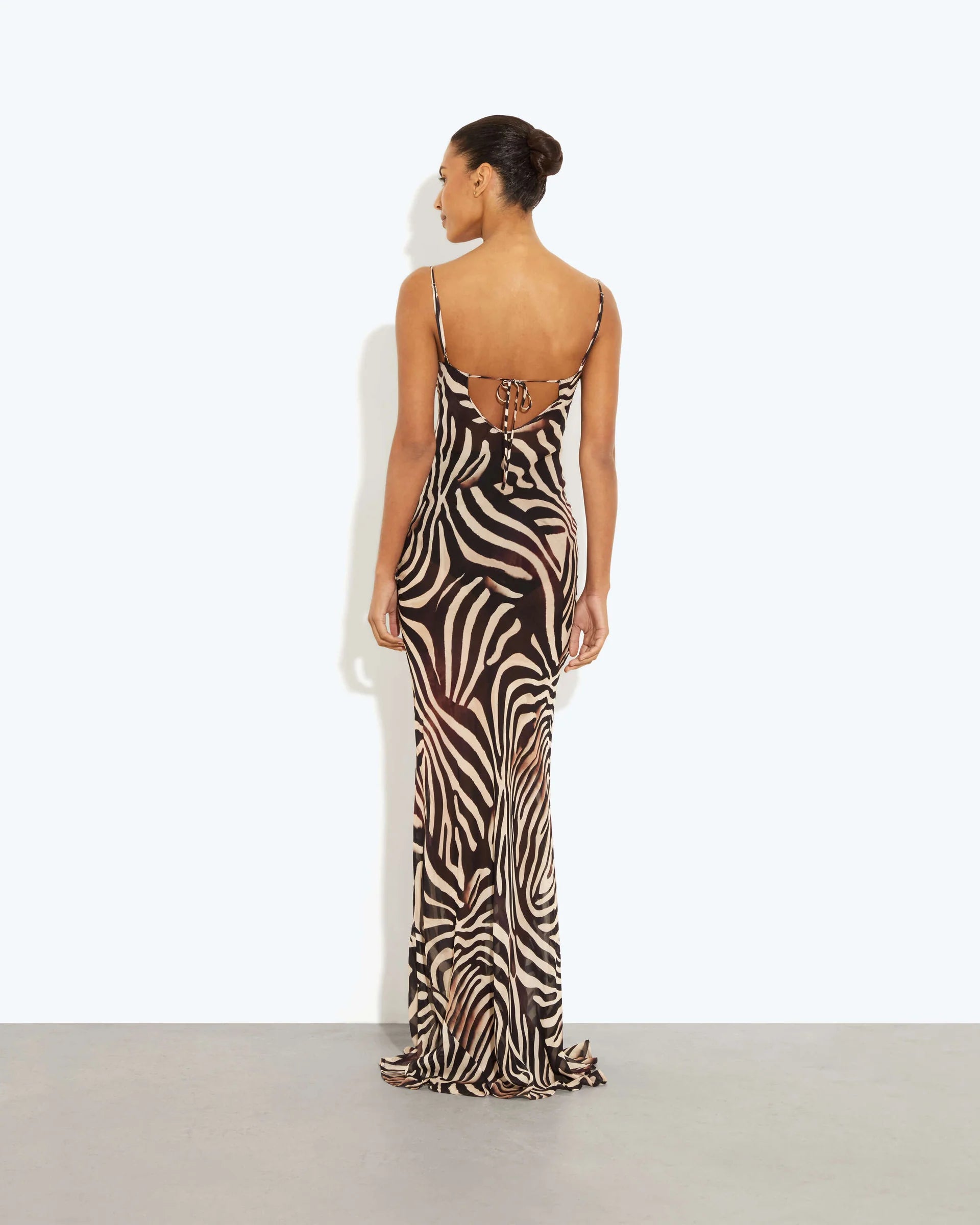 Woman wearing black and cream zebra stripe maxi dress with cowl neckline — Endless | Endless UAE