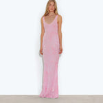 Woman wearing pink sleeveless maxi dress standing between dried palm fronds — Rat & Boa | Endless UAE