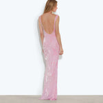 Woman wearing pink sleeveless maxi dress standing between dried palm fronds — Rat & Boa | Endless UAE