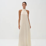Elegant ivory halter neck maxi dress with high neckline and flowing silhouette — Nora The Label | Endless UAE