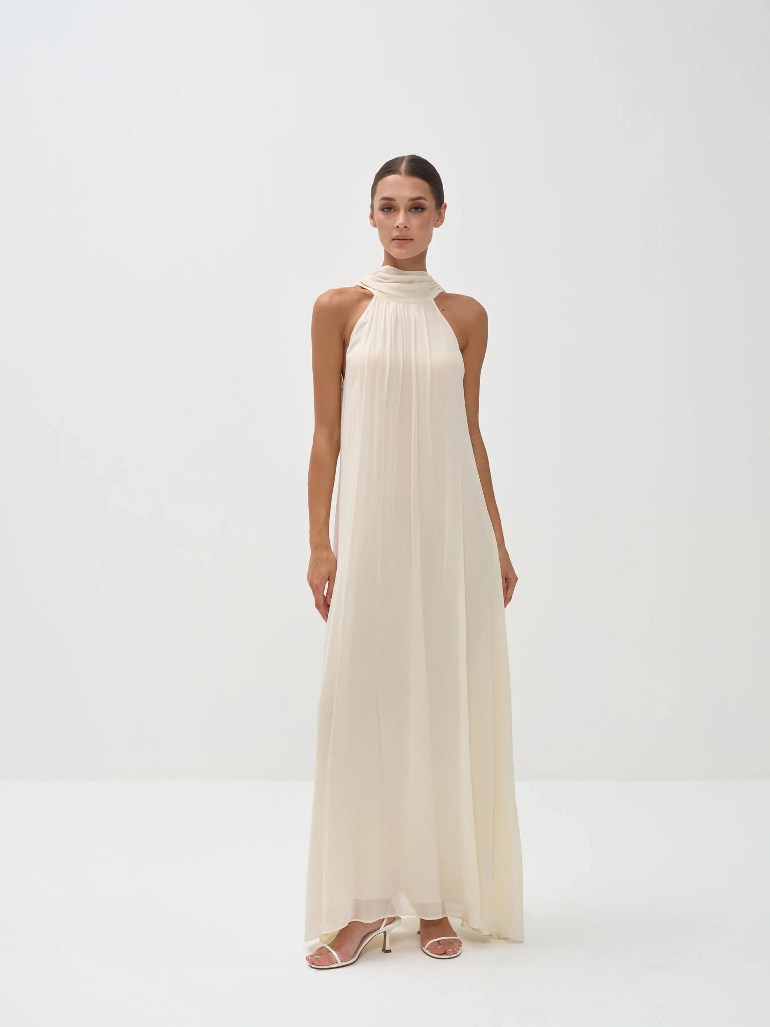 Elegant ivory halter neck maxi dress with high neckline and flowing silhouette — Nora The Label | Endless UAE