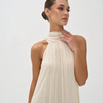 Elegant cream halter neck maxi dress with draped neckline and flowing silhouette — Nora The Label | Endless UAE