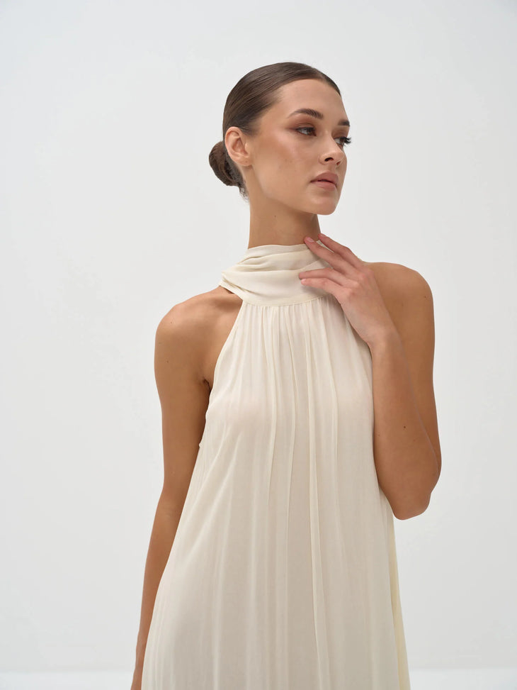 Elegant cream halter neck maxi dress with draped neckline and flowing silhouette — Nora The Label | Endless UAE