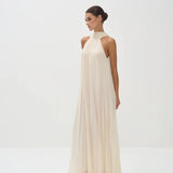 Elegant cream halter neck maxi dress with flowing pleated fabric and floor-length silhouette — Nora The Label | Endless UAE