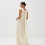 Elegant cream halter neck maxi dress with flowing silhouette and floor-length hem — Nora The Label | Endless UAE