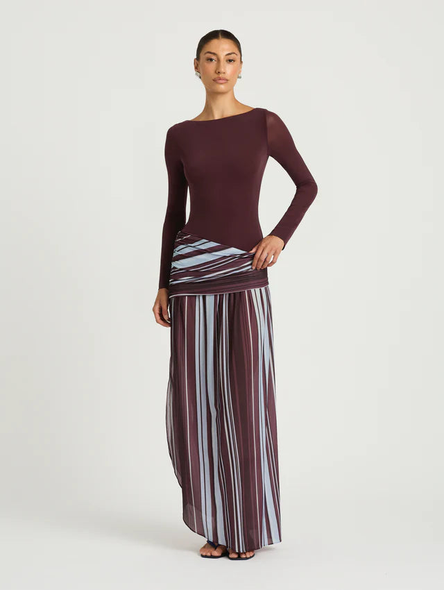 Woman wearing burgundy long sleeve maxi dress with striped skirt detail — BENNI. | Endless UAE