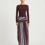Woman wearing burgundy long sleeve maxi dress with striped skirt detail — BENNI. | Endless UAE
