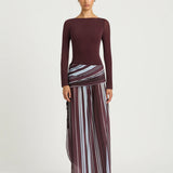 Woman wearing burgundy long sleeve maxi dress with striped skirt detail — BENNI. | Endless UAE