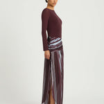 Woman wearing burgundy long sleeve maxi dress with striped skirt detail — BENNI. | Endless UAE