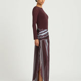 Woman wearing burgundy long sleeve maxi dress with striped skirt detail — BENNI. | Endless UAE