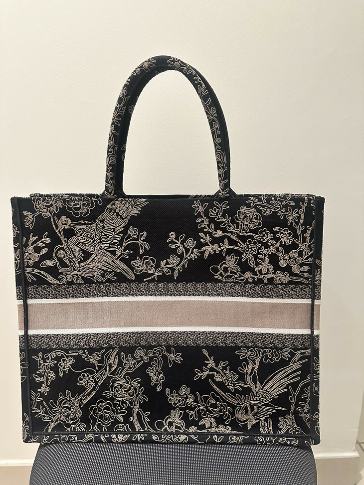Black embroidered tote bag with bird and floral motifs, featuring beige striped canvas panel and dual handles — Christian Dior | Endless UAE