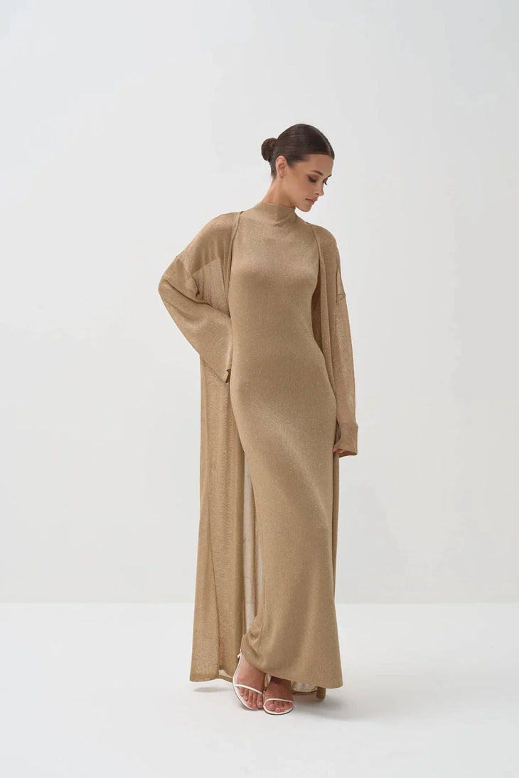 Elegant gold shimmer maxi dress with matching duster cardigan, featuring mock neck and long sleeves — Nora The Label | Endless UAE