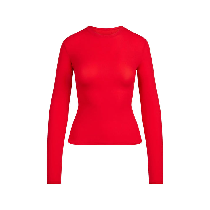Red long sleeve fitted t-shirt paired with black mini skirt — Skims | Endless UAE