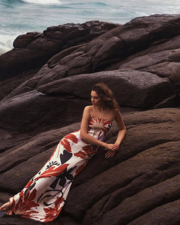 Woman wearing red and white floral maxi dress standing in modern corridor — Second Summer | Endless UAE