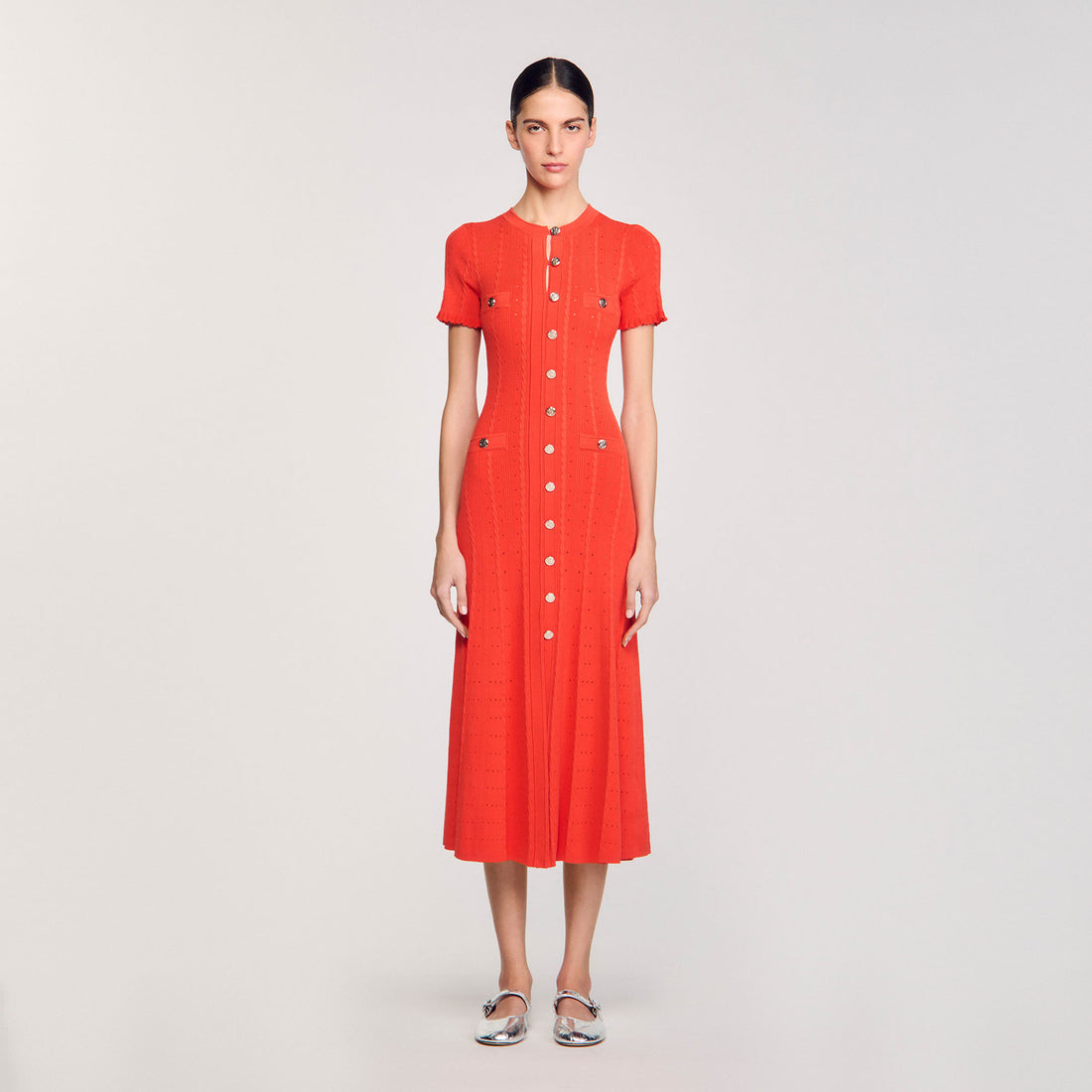 Orange button-front knit midi dress with short sleeves and flared skirt on model — Sandro | Endless UAE