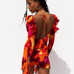 Vibrant abstract print mini dress with ruffled open back and long sleeves in red, orange and pink tones — Rat & Boa | Endless UAE