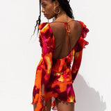 Vibrant abstract print mini dress with ruffled open back and long sleeves in red, orange and pink tones — Rat & Boa | Endless UAE