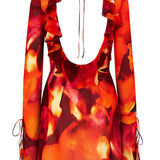 Vibrant flame-print mini dress with ruffle neckline, long sleeves, and tie details in red, orange, and yellow tones — Rat & Boa | Endless UAE