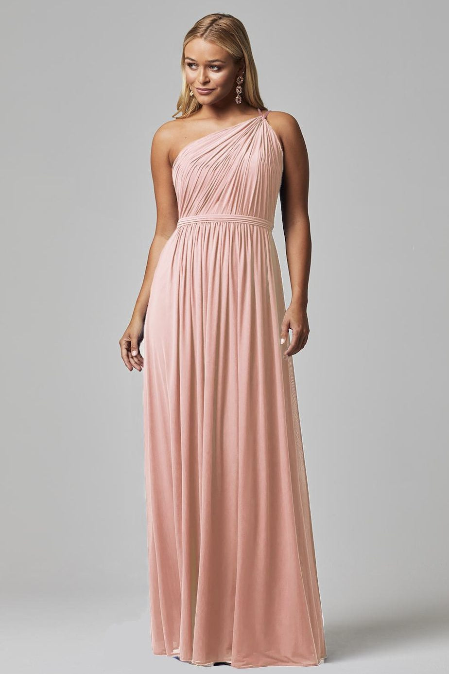 Elegant blush pink one-shoulder bridesmaid dress with pleated bodice and flowing chiffon skirt — You&I Bridal | Endless UAE