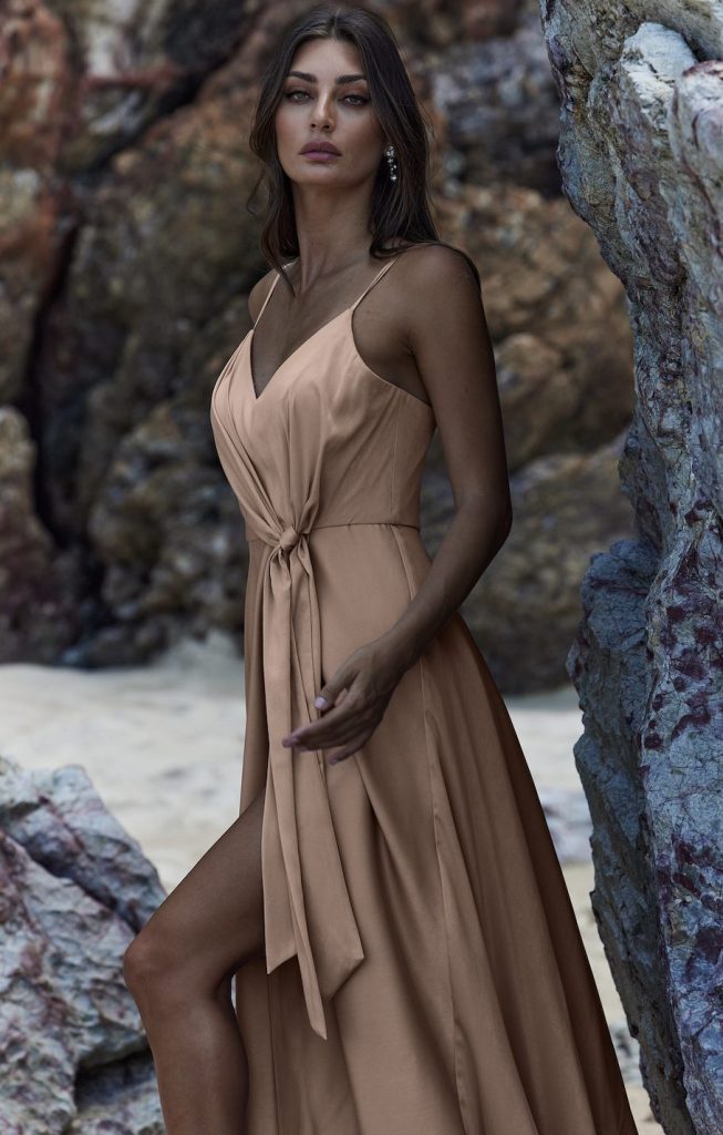 Flowing beige wrap dress with spaghetti straps and tie waist detail, featuring a high slit — You&I Bridal | Endless UAE
