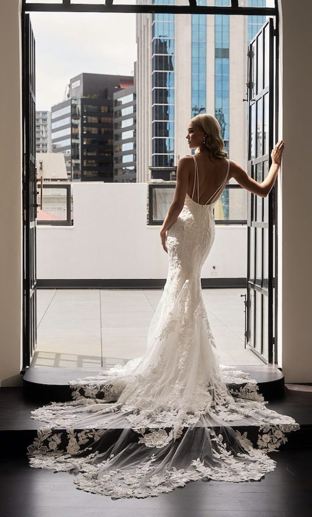 Bride in white lace mermaid gown with dramatic train at balcony — JESSICA COUTURE | Endless UAE