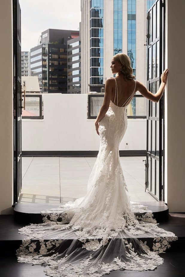 Bride in white lace mermaid gown with dramatic train at balcony — JESSICA COUTURE | Endless UAE