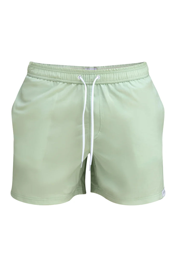 Sage green swim trunks with white drawstring and elastic waistband on white background — Miharo | Endless UAE