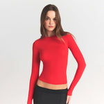 Red long sleeve fitted t-shirt paired with black mini skirt — Skims | Endless UAE