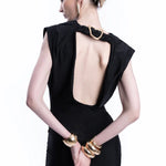 Woman wearing black sleeveless maxi dress with ruched side detail and gold bangles — Lediel | Endless UAE