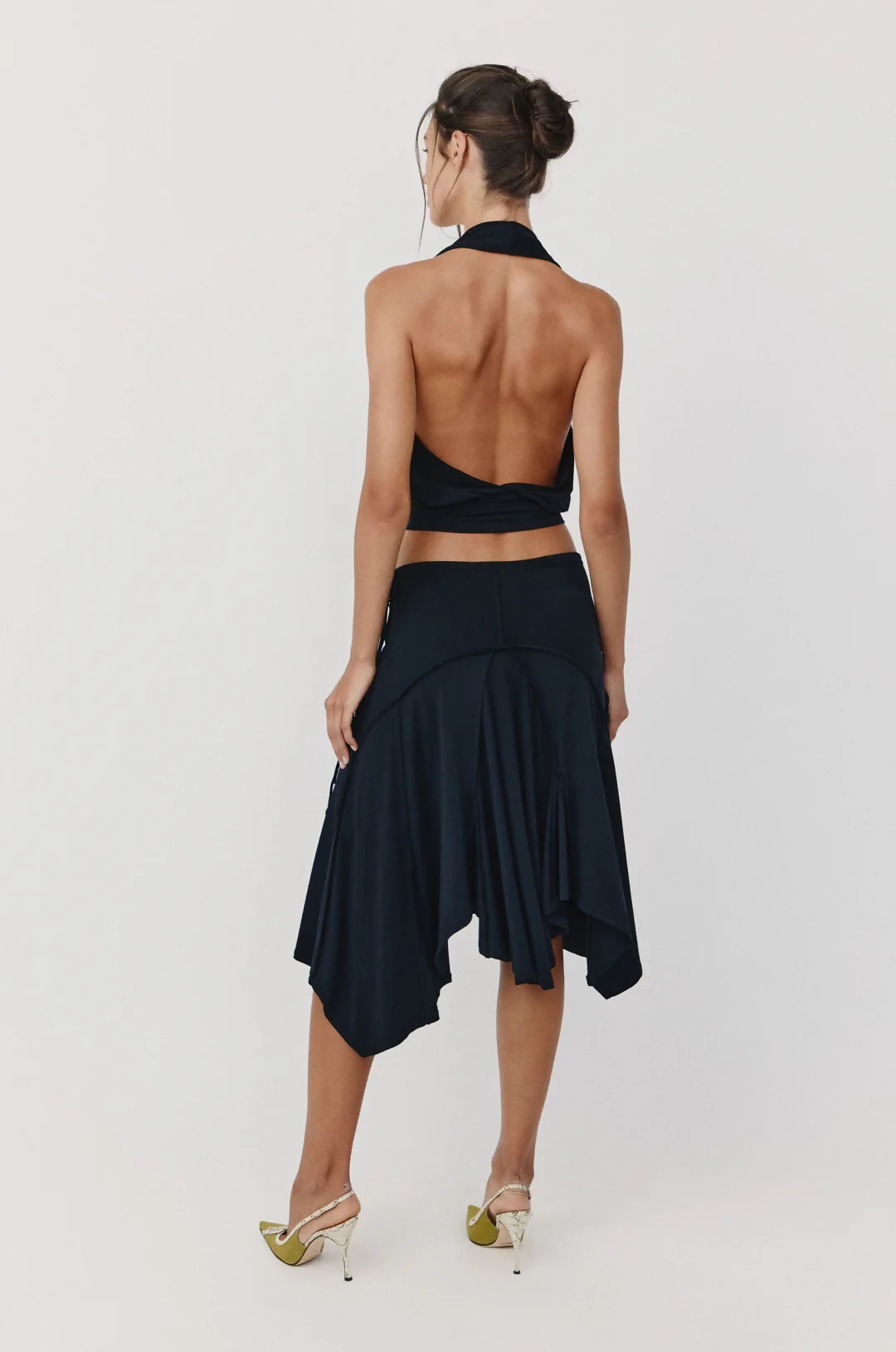 Black halter crop top and asymmetrical handkerchief skirt set, back view showing open back design — With Jean | Endless UAE