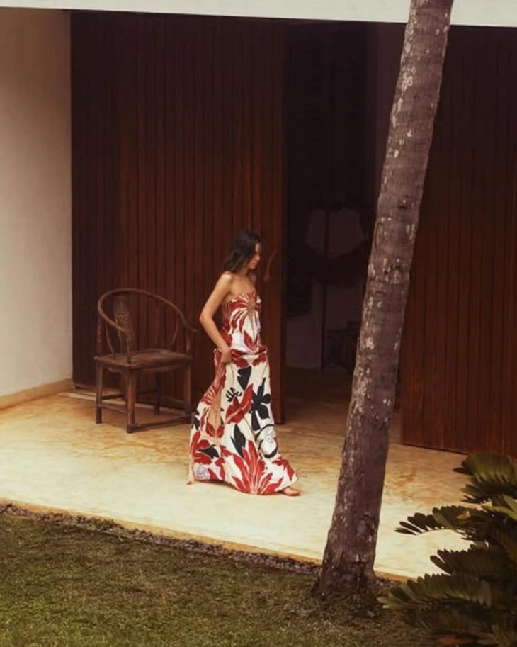 Woman wearing red and white floral maxi dress standing in modern corridor — Second Summer | Endless UAE
