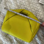 Yellow leather Twister Nano crossbody bag being measured with ruler showing compact size — JW Anderson | Endless UAE