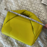 Yellow leather Twister Nano crossbody bag being measured with ruler showing compact size — JW Anderson | Endless UAE