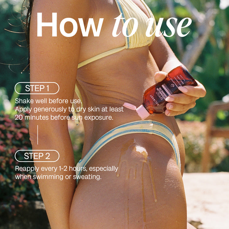 SPF50 Watermelon Tanning Oil sunscreen in amber bottle with pink cap — Bali Body | Endless UAE