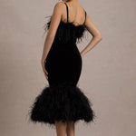 Woman wearing black velvet midi dress with feather trim and spaghetti straps — Club L London | Endless UAE