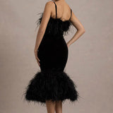 Woman wearing black velvet midi dress with feather trim and spaghetti straps — Club L London | Endless UAE