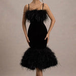 Woman wearing black velvet midi dress with feather trim and spaghetti straps — Club L London | Endless UAE