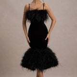 Woman wearing black velvet midi dress with feather trim and spaghetti straps — Club L London | Endless UAE