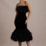 Woman wearing black velvet midi dress with feather trim and spaghetti straps — Club L London | Endless UAE