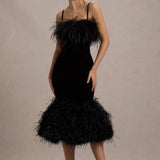 Woman wearing black velvet midi dress with feather trim and spaghetti straps — Club L London | Endless UAE