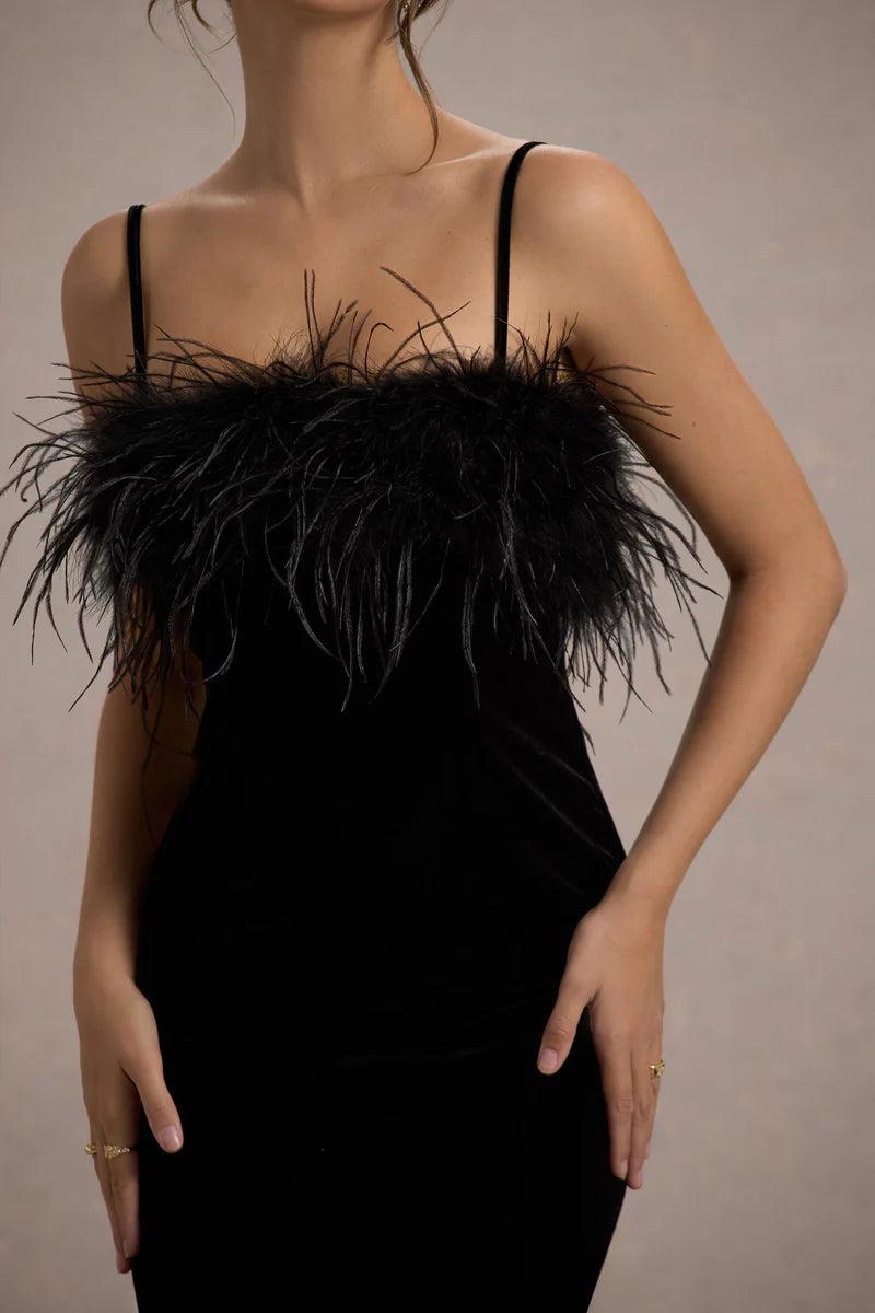 Woman wearing black velvet midi dress with feather trim and spaghetti straps — Club L London | Endless UAE