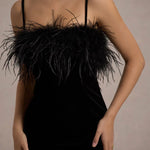 Woman wearing black velvet midi dress with feather trim and spaghetti straps — Club L London | Endless UAE