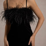 Woman wearing black velvet midi dress with feather trim and spaghetti straps — Club L London | Endless UAE