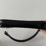 Black crocodile embossed leather shoulder bag held in hand against white background — By Far | Endless UAE