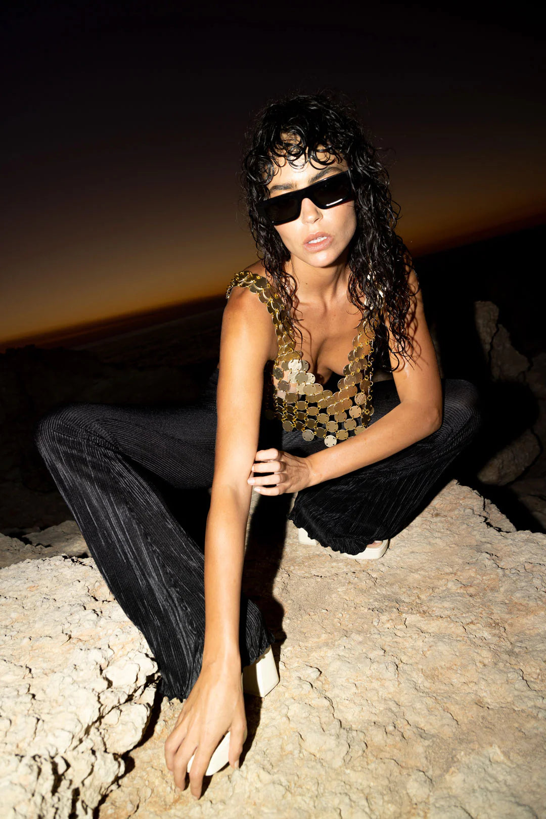 Black and gold sequin tank top worn by model on beach at night — Isabel Moore | Endless UAE