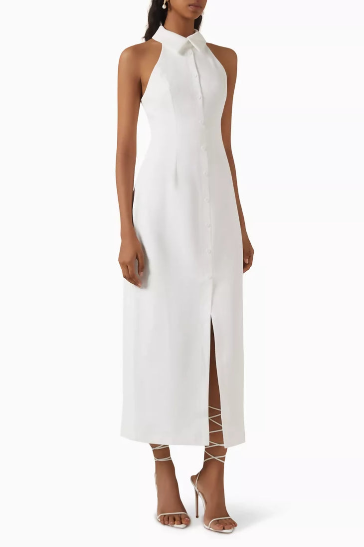 Woman wearing white sleeveless halter maxi dress with front slit and white strappy heels — Odd Muse | Endless UAE