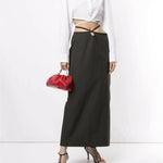 White cropped silk shirt with wrap-around tie detail and long sleeves styled with black skirt — Christopher Esber | Endless UAE